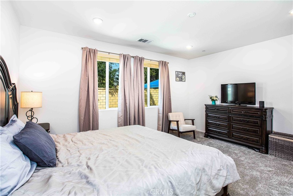 14563 Gulfstream Lane Moreno Valley, CA 92553 - Photo 12 of 30 a bedroom with a bed and wooden floor