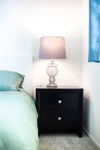 a bedroom with a bed and lamp