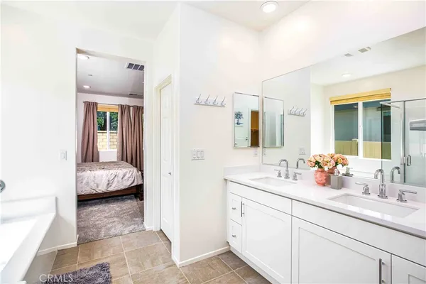 a en suite bathroom with a double sink and mirror