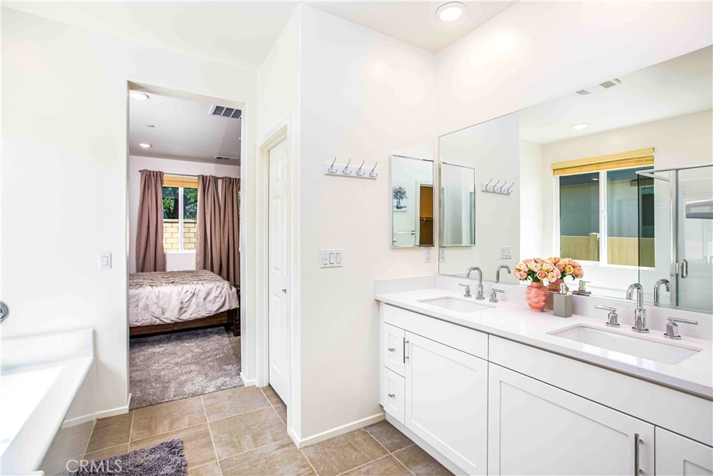 14563 Gulfstream Lane Moreno Valley, CA 92553 - Photo 18 of 30 a en suite bathroom with a double sink and mirror