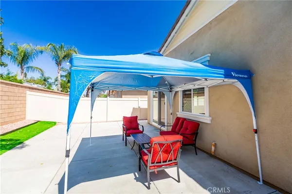 a patio with lawn chairs and wooden floor