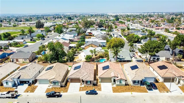 an aerial view of residential houses with outdoor space