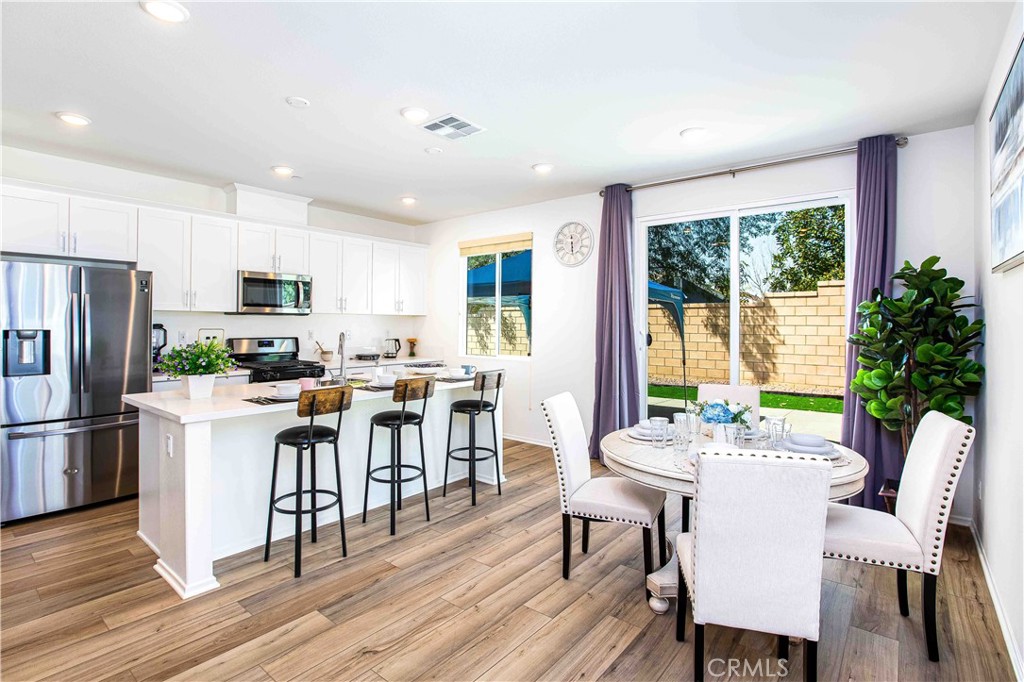14563 Gulfstream Lane Moreno Valley, CA 92553 - Photo 6 of 30 a view of a dining room with furniture window and wooden floor