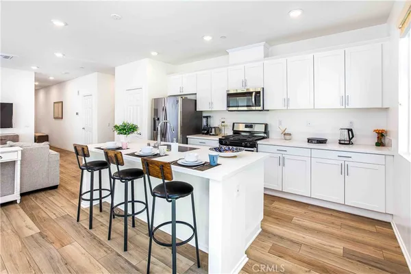 a kitchen with stainless steel appliances kitchen island granite countertop a sink and cabinets