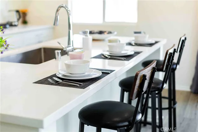 a kitchen with a dining table chairs and stove