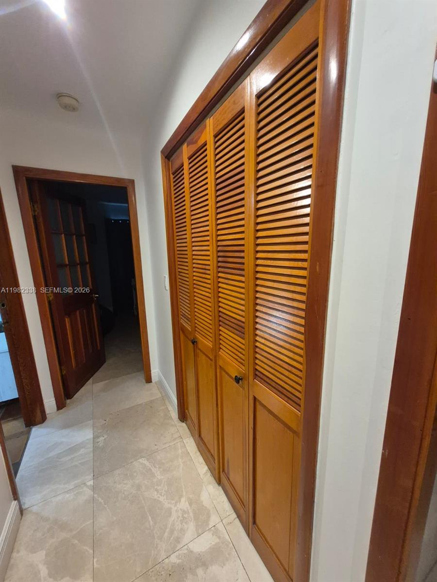 14530 Southwest 110th Street Miami, FL 33186 - Photo 26 of 45 a view of a hallway with wooden walls