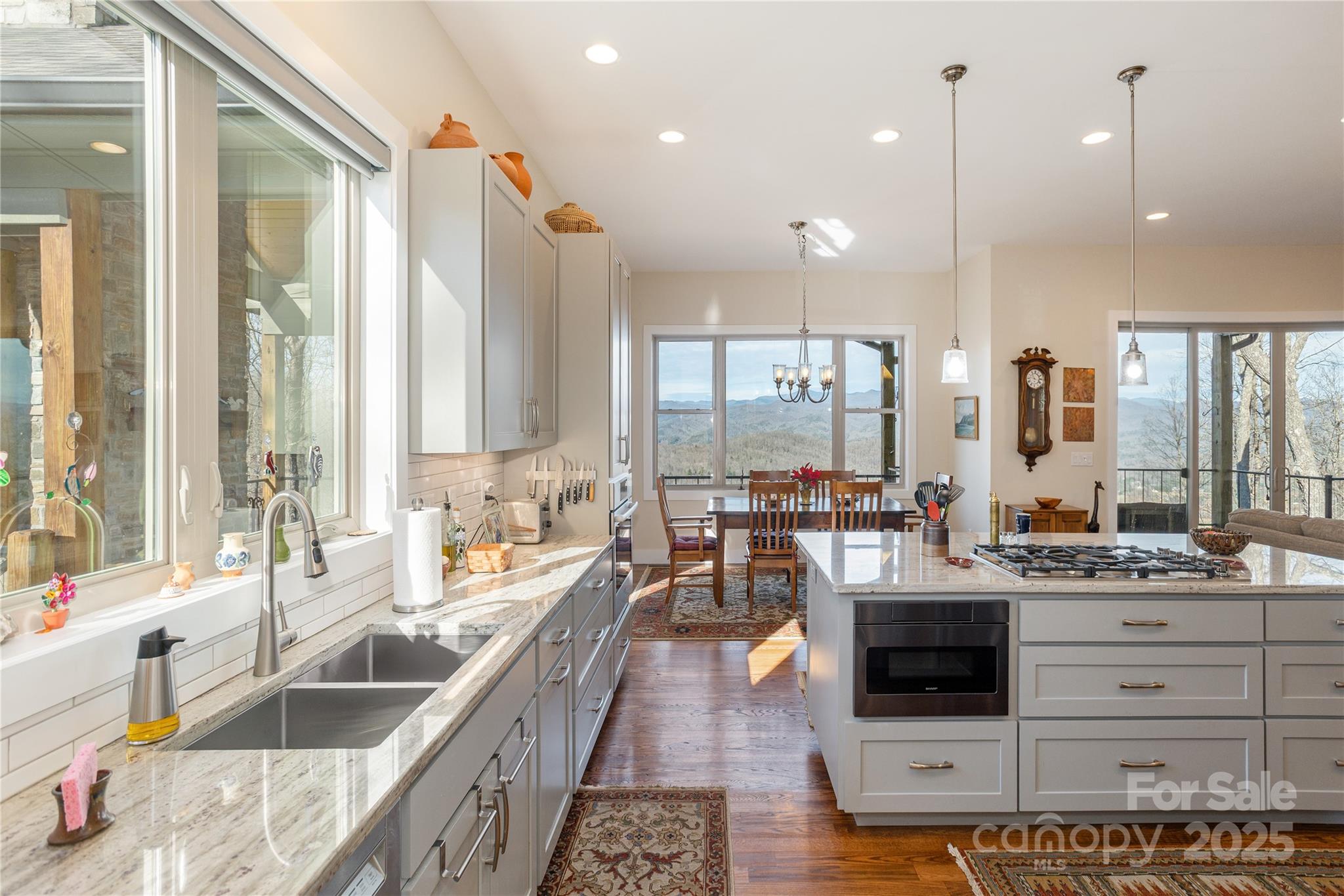 69 Pepperbush Road Brevard, NC 28712 - Photo 9 of 34 a large kitchen with stainless steel appliances kitchen island granite countertop a large window and a sink