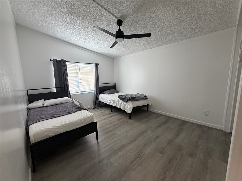 1910 Rio Grande Road Bullhead City, AZ 86442 - Photo 20 of 29 Bright room featuring wood-finish flooring, a contemporary ceiling fan, and a window with blinds
