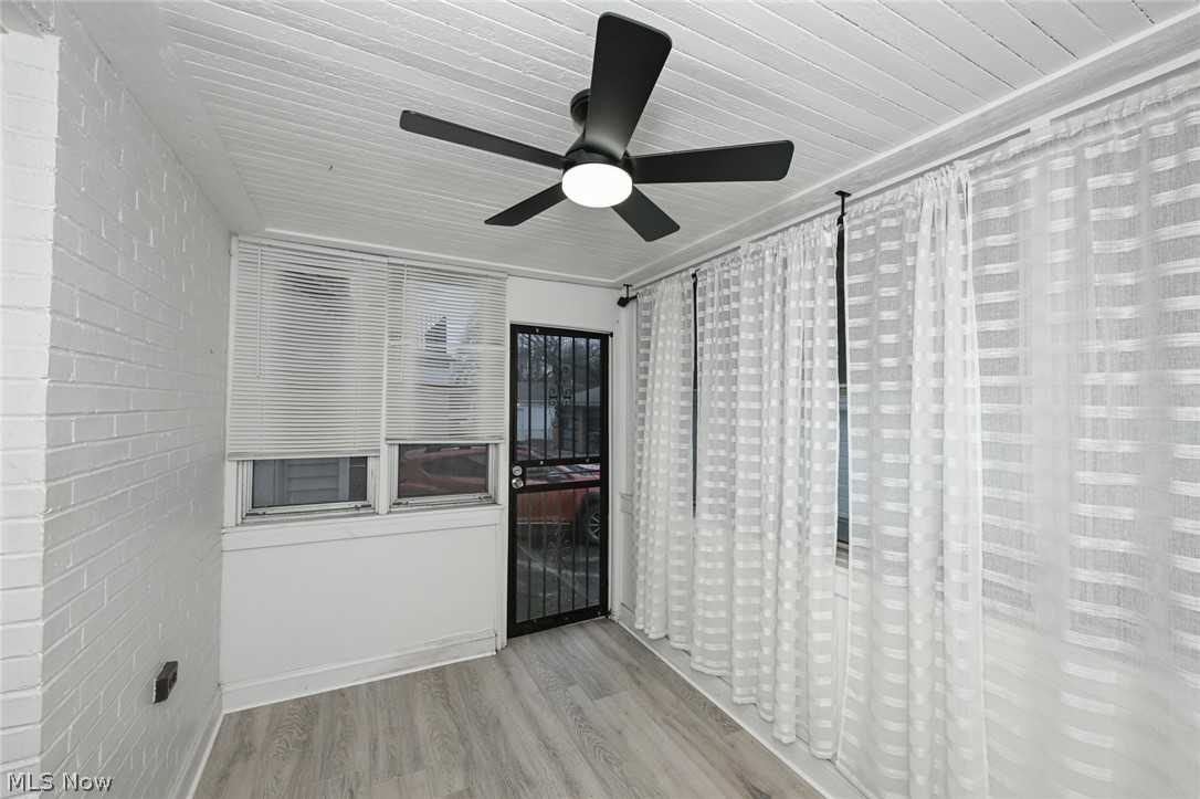3699 Bainbridge Road Cleveland Heights, OH 44118 - Photo 19 of 37 Enclosed porch with wood-finish flooring, white painted brick wall, and a slatted ceiling
