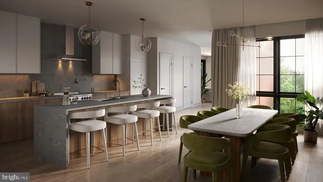 a kitchen with stainless steel appliances granite countertop a table chairs and a refrigerator