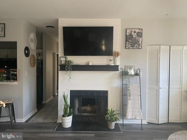 602 Moonglow Road, Unit 201 Odenton, MD 21113 - Photo 2 of 8 a living room with a fireplace and a flat screen tv