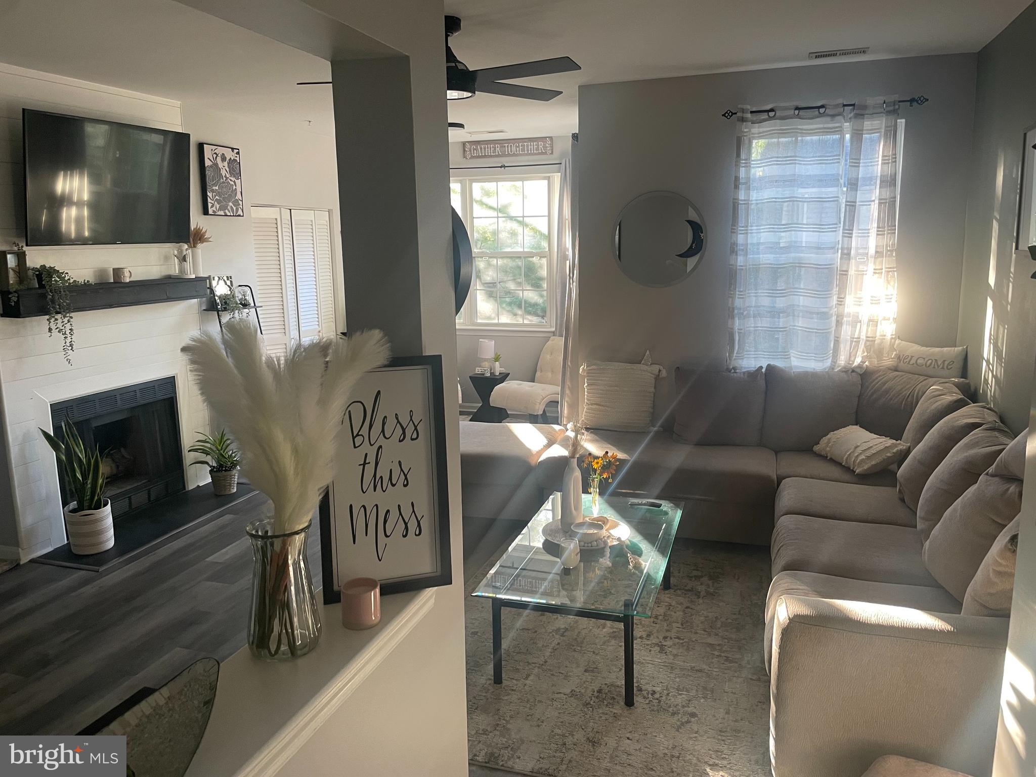 602 Moonglow Road, Unit 201 Odenton, MD 21113 - Photo 4 of 8 a living room with furniture a flat screen tv and a fireplace