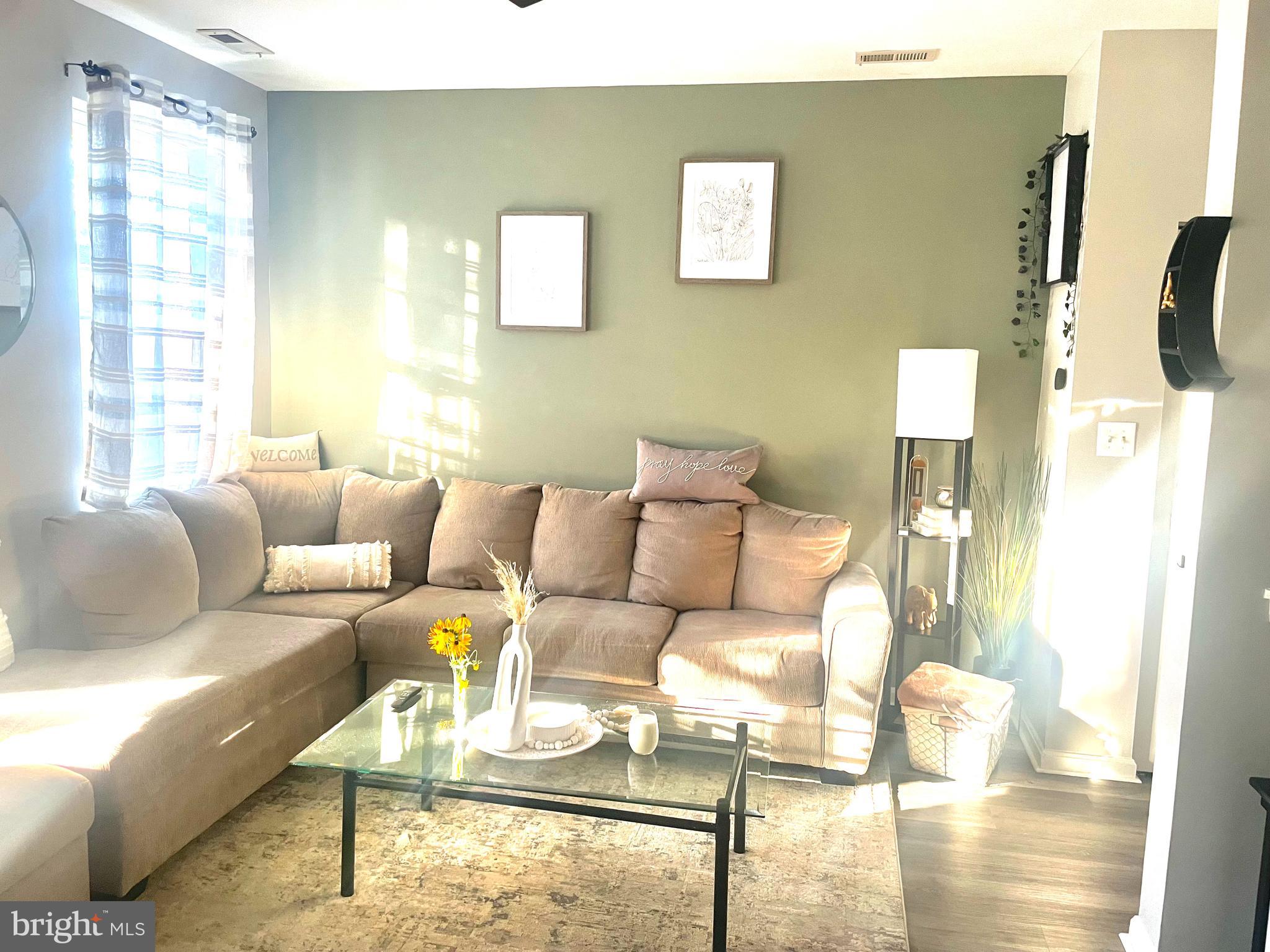 602 Moonglow Road, Unit 201 Odenton, MD 21113 - Photo 5 of 8 a living room with furniture and a floor to ceiling window