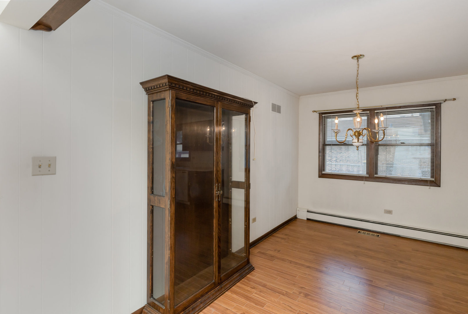 18303 Bock Road Lansing, IL 60438 - Photo 4 of 29 an empty room with wooden floor cabinet and windows
