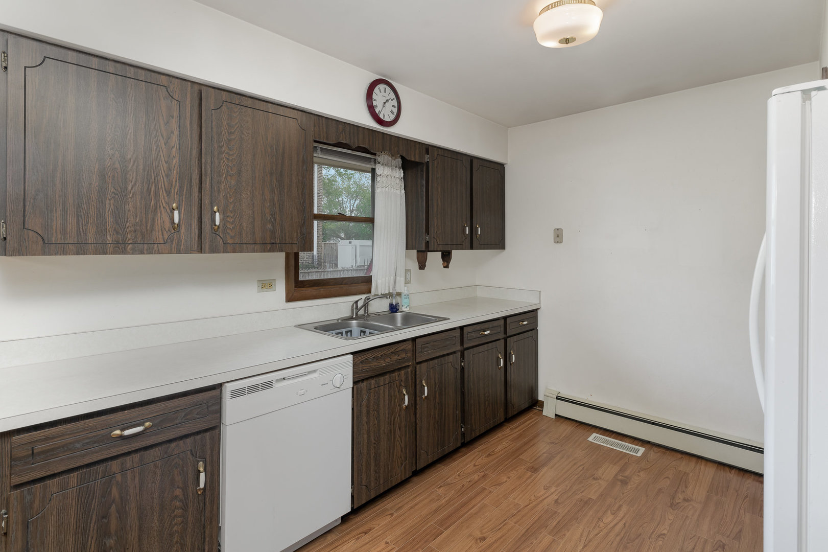 18303 Bock Road Lansing, IL 60438 - Photo 7 of 29 a kitchen with a sink cabinets and wooden floor