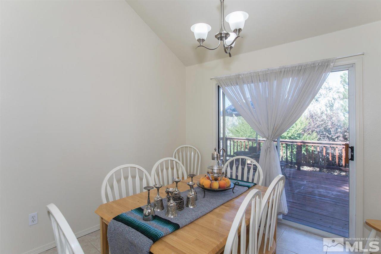 15185 Sylvester Road Reno, NV 89521 - Photo 6 of 25 a view of a dining room with furniture window and outside view