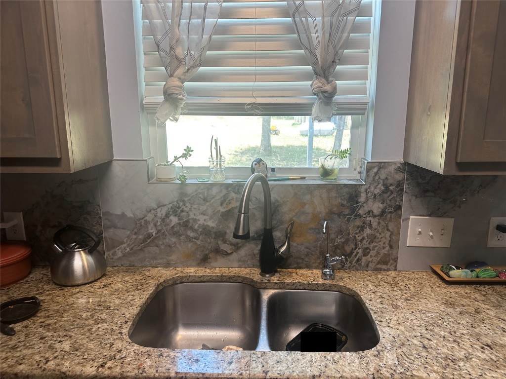1231 Oak Grove Road Luling, TX 78648 - Photo 32 of 40 a kitchen with a sink and a granite top