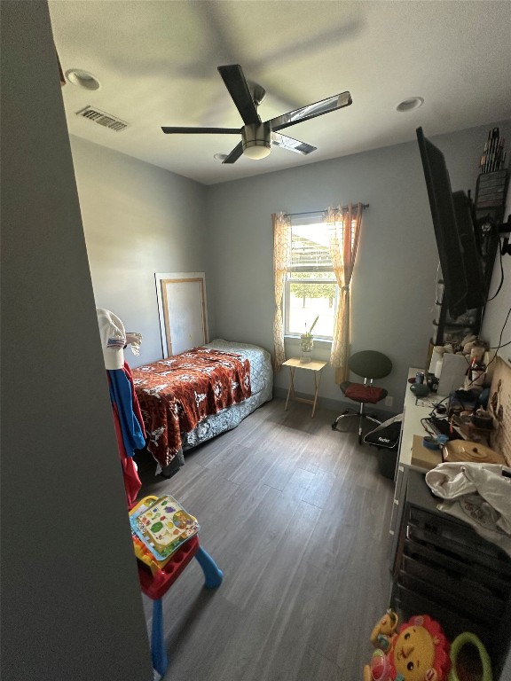 1231 Oak Grove Road Luling, TX 78648 - Photo 39 of 40 a bedroom with furniture and a wooden floor