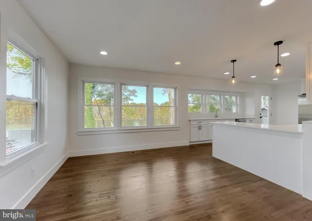a view of hallway with wooden floor and entryway