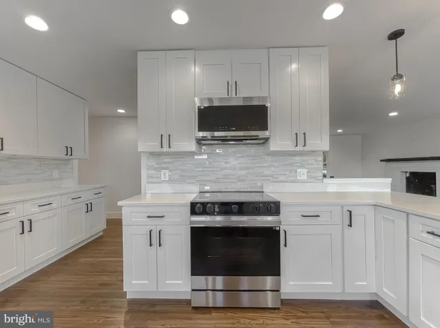 a view of a small space with wooden floor and a window