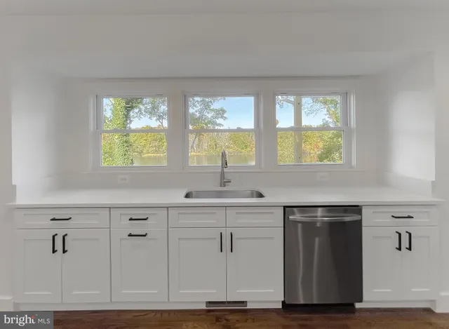 a bathroom with a sink vanity and mirror
