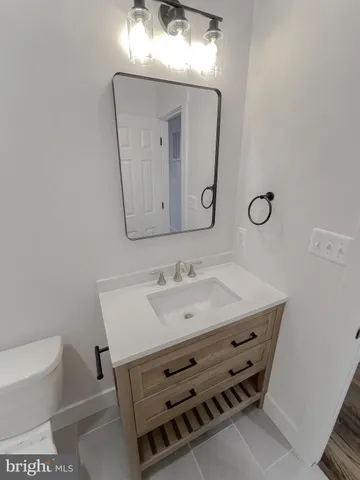 a view of an empty room with a kitchen