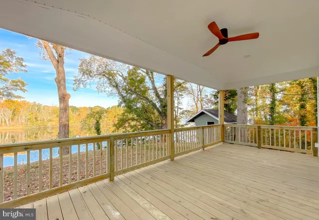 a view of an empty room with a fireplace and a window