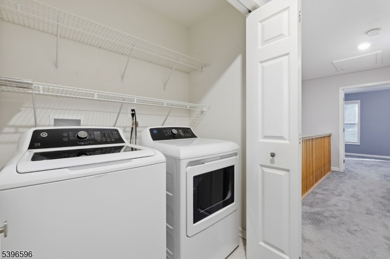 335 Wilshire Drive Nutley, NJ 07110 - Photo 11 of 23 a view of washer and dryer with kitchen in the background