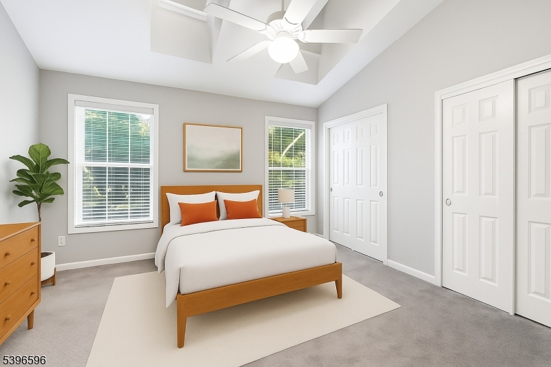 335 Wilshire Drive Nutley, NJ 07110 - Photo 13 of 23 a bedroom with a large bed and a chandelier fan