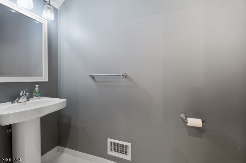 335 Wilshire Drive Nutley, NJ 07110 - Photo 6 of 23 a bathroom with a sink a mirror and a toilet