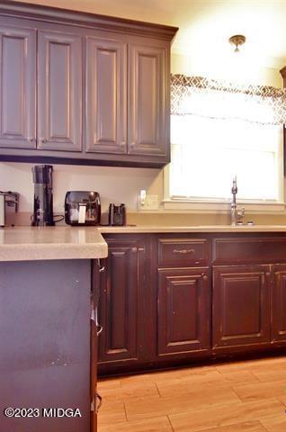 514 Ashby Way Warner Robins, GA 31088 - Photo 11 of 26 a kitchen with stainless steel appliances granite countertop a sink and cabinets with wooden floor