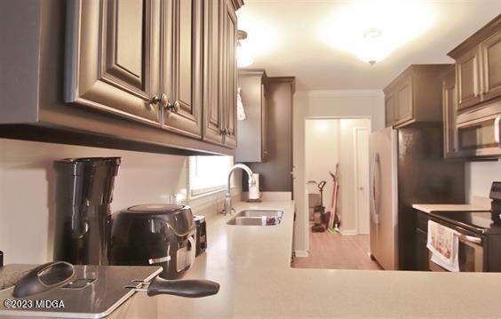514 Ashby Way Warner Robins, GA 31088 - Photo 16 of 26 a kitchen with stainless steel appliances kitchen island granite countertop a refrigerator and a sink