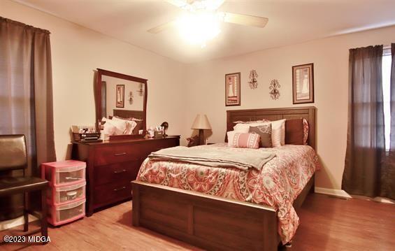 514 Ashby Way Warner Robins, GA 31088 - Photo 17 of 26 a bedroom with bed and wooden floor