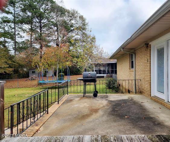 514 Ashby Way Warner Robins, GA 31088 - Photo 22 of 26 a view of house with outdoor seating and trees