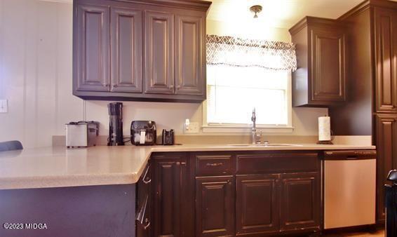 514 Ashby Way Warner Robins, GA 31088 - Photo 10 of 26 a kitchen with granite countertop a sink stainless steel appliances and cabinets