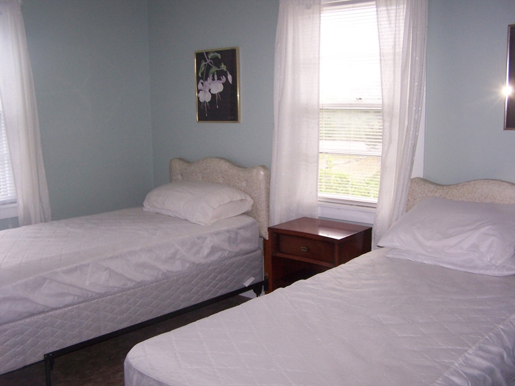 334 Phillips Sagamore Beach, MA 02562 - Photo 5 of 5 a bedroom with a bed and a window