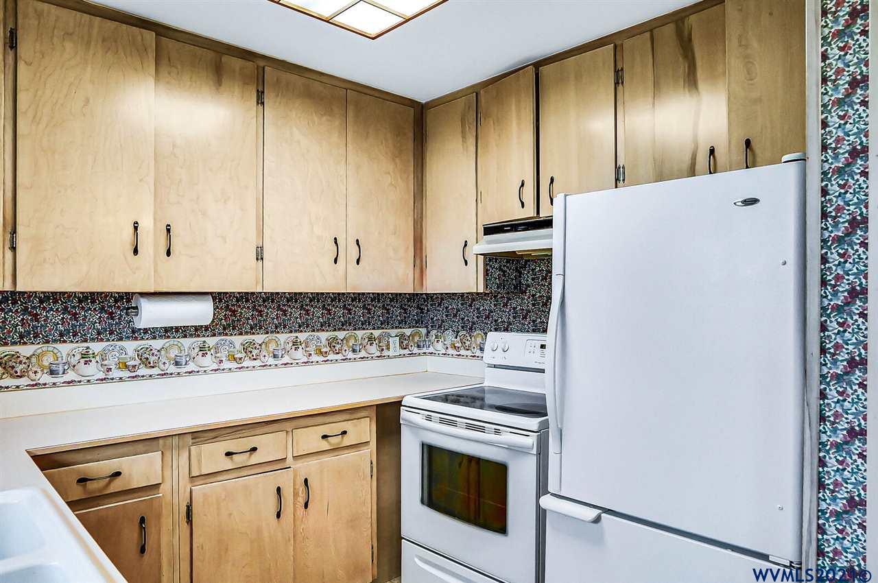 156 Northwest Reed Lane Dallas, OR 97338 - Photo 13 of 39 a kitchen with granite countertop cabinets stainless steel appliances and sink