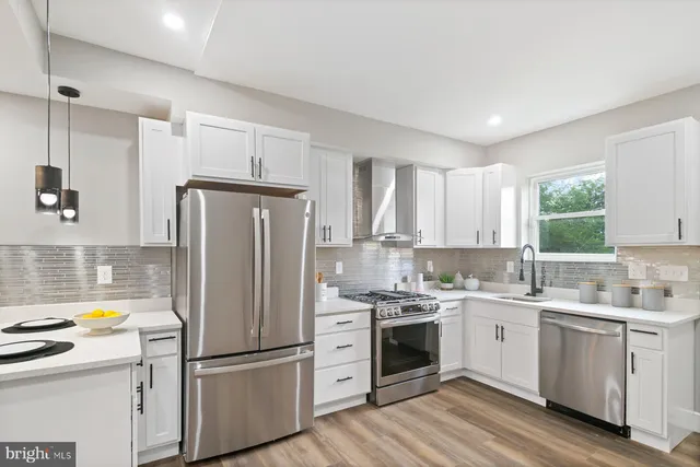 a kitchen with a white cabinets and stainless steel appliances