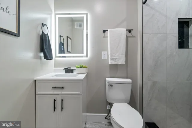 a bathroom with a glass shower door
