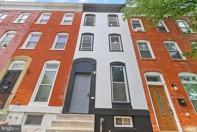 a view of a house with brick walls
