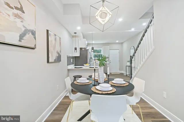 a view of a dining room with furniture and a chandelier