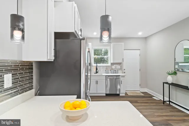 a kitchen with a sink appliances and cabinets
