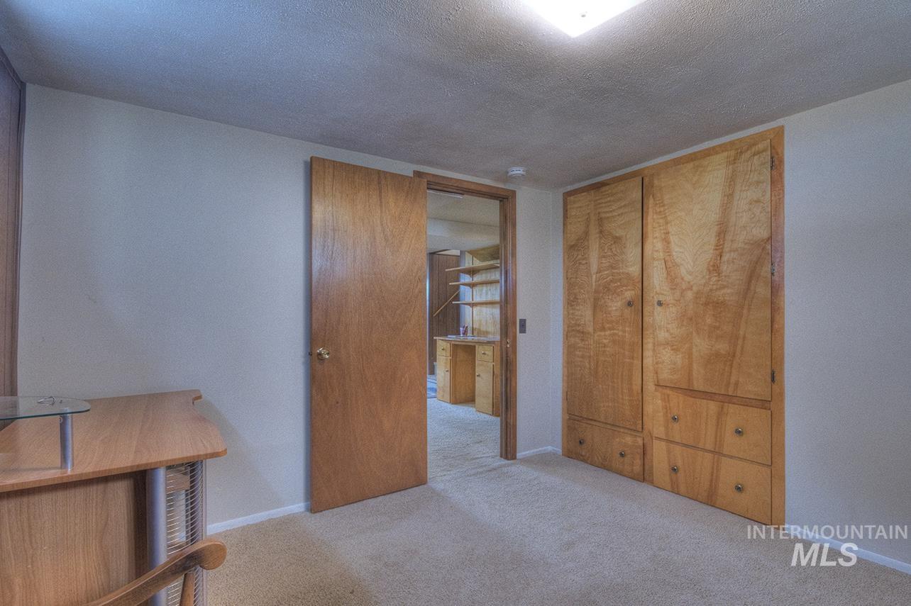 351 West Main Street South Vale, OR 97918 - Photo 14 of 33 Light-colored carpeting complementing neutral wall tones (no egress/ingress assessor has classified as a bedroom)
