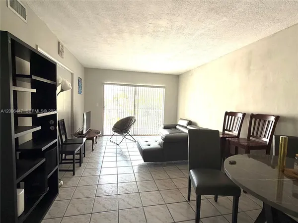 a living room with furniture a air conditioner vent and a window