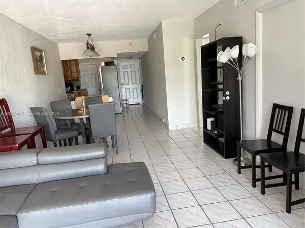 a living room with furniture and a mirror
