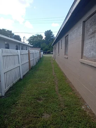 a view of a backyard with wooden fence