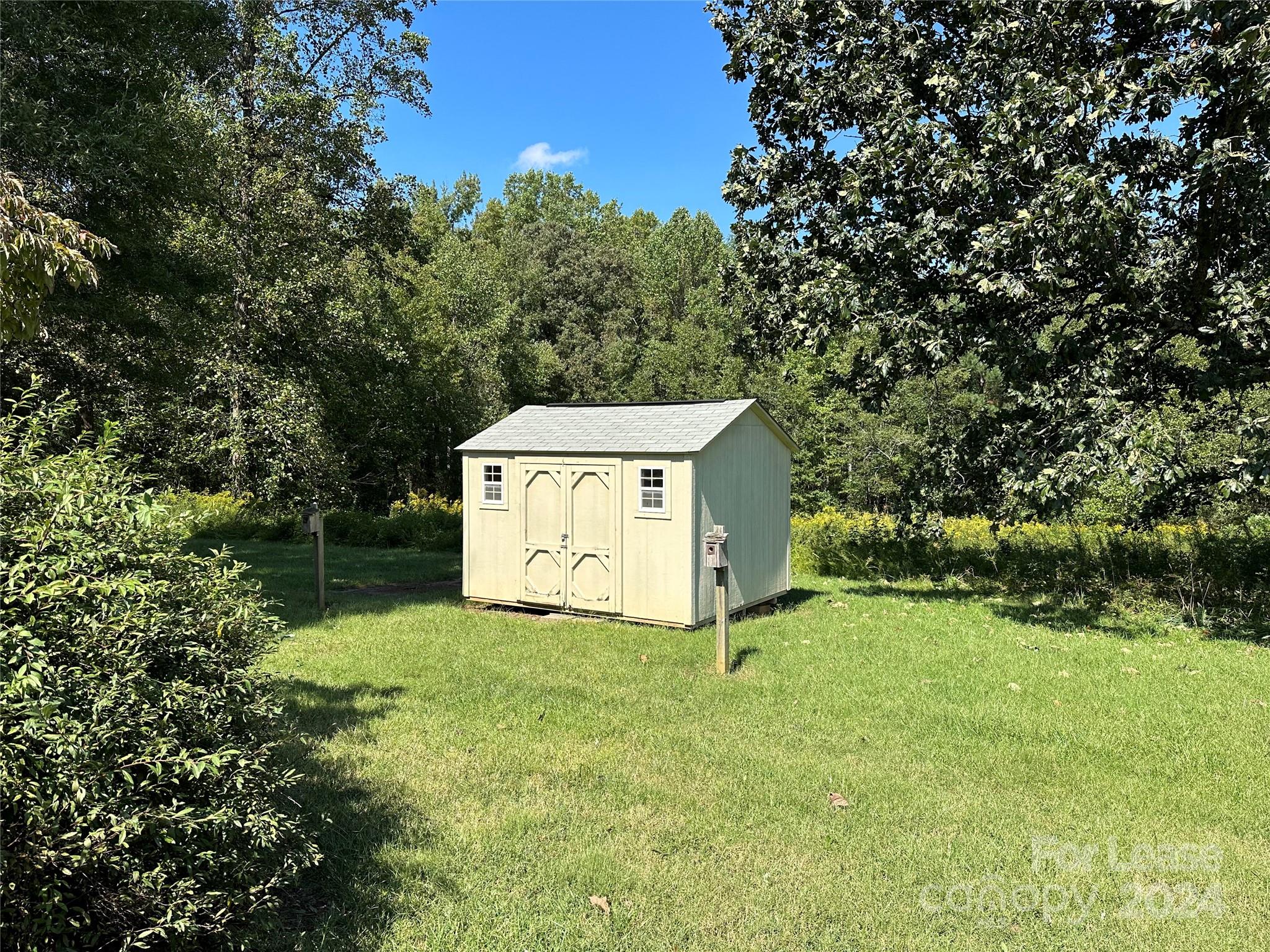 147 Sinclair Road Mooresville, NC 28115 - Photo 18 of 21 a view of a tiny house with a yard