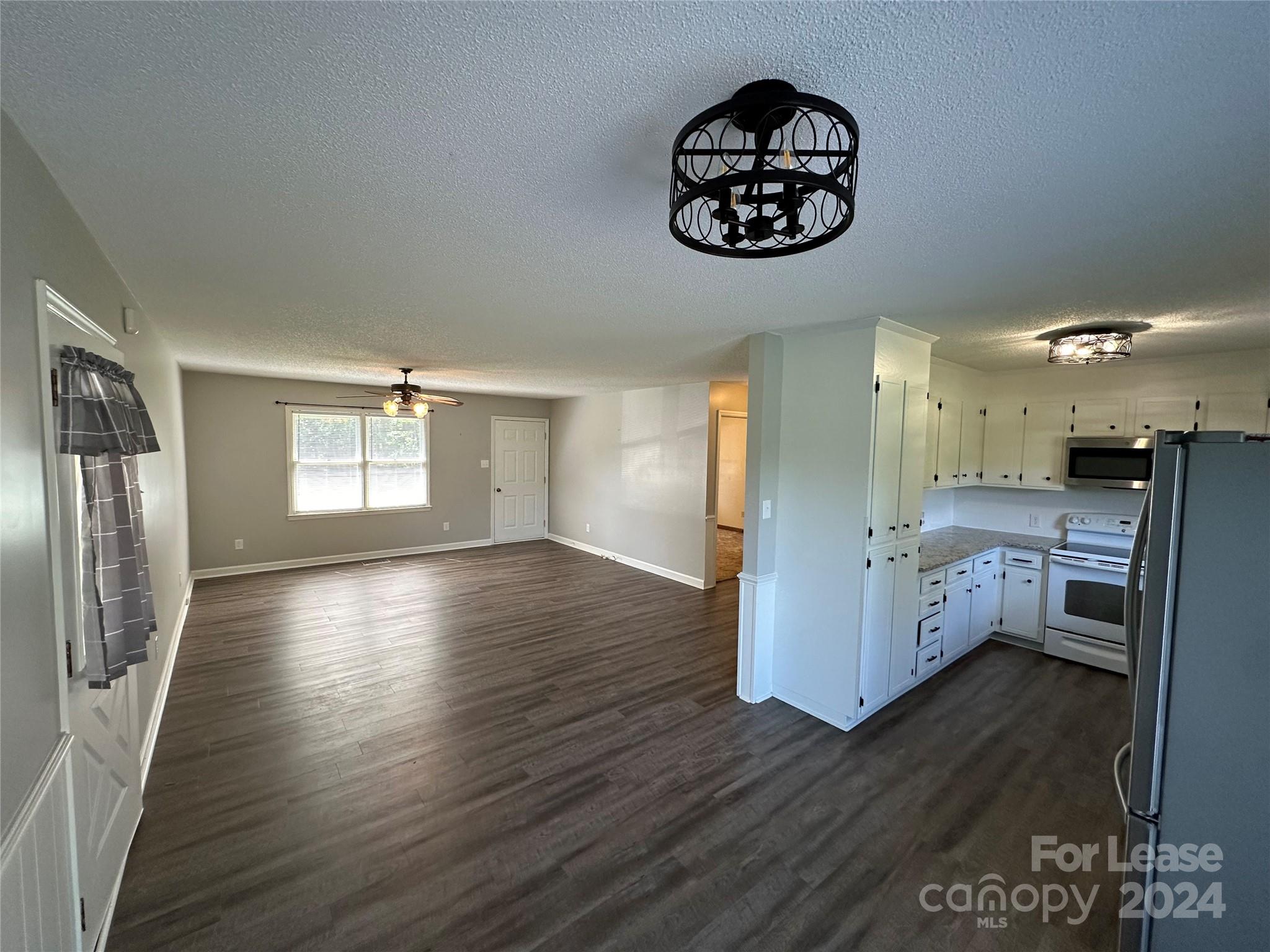 147 Sinclair Road Mooresville, NC 28115 - Photo 2 of 21 a view of a room with wooden floor and window