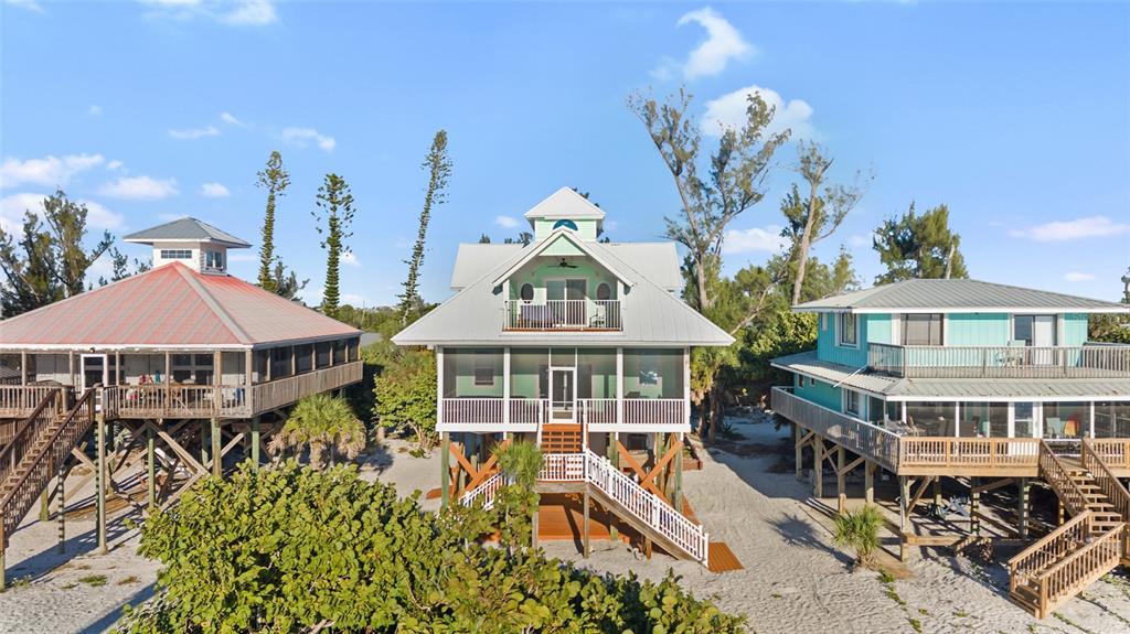 8798 Grand Avenue Boca Grande, FL 33921 - Photo 1 of 64 an aerial view of a house with swimming pool and large trees