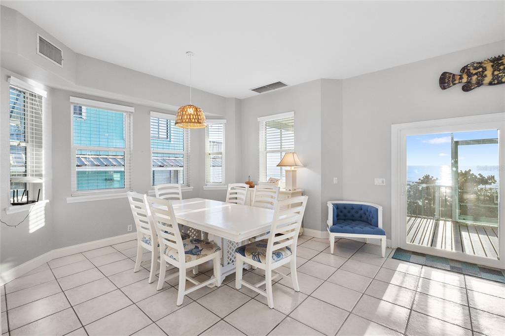 8798 Grand Avenue Boca Grande, FL 33921 - Photo 12 of 64 a view of a dining room with furniture and a potted plant